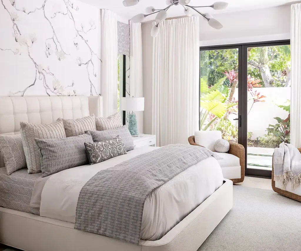 Serene white bedroom with garden views styled by Abodeable Home