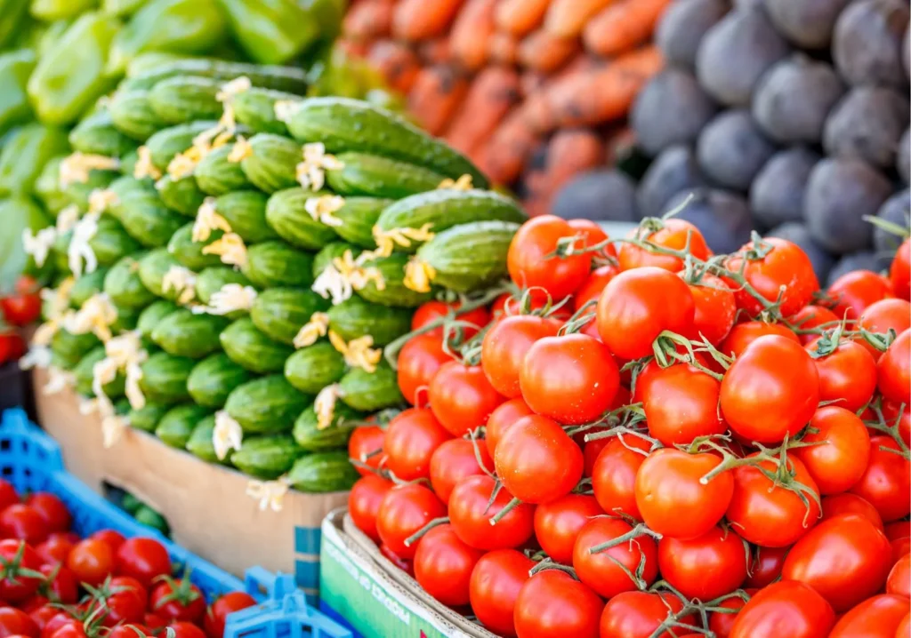 Stacks of corn, tomatoes and other vegetables