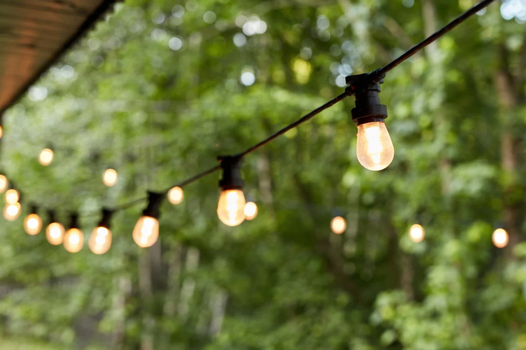 String of outdoor decorative lights in a backyard