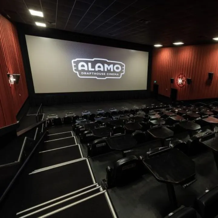 Theater auditorium with dining seats at Alamo Drafthouse Naples