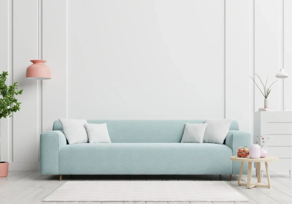 Turquoise sofa with 4 small white pillows