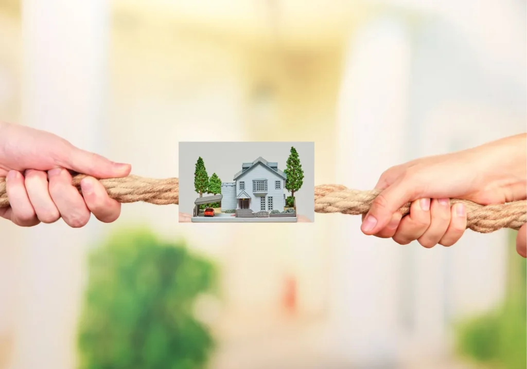 Two people having a tug-of-war over home purchasing options