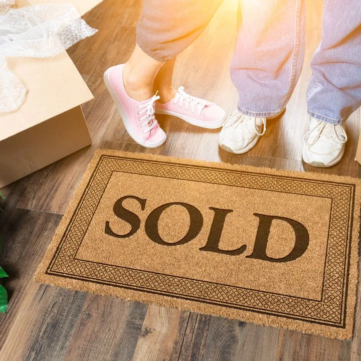 Two people standing on SOLD floor mat