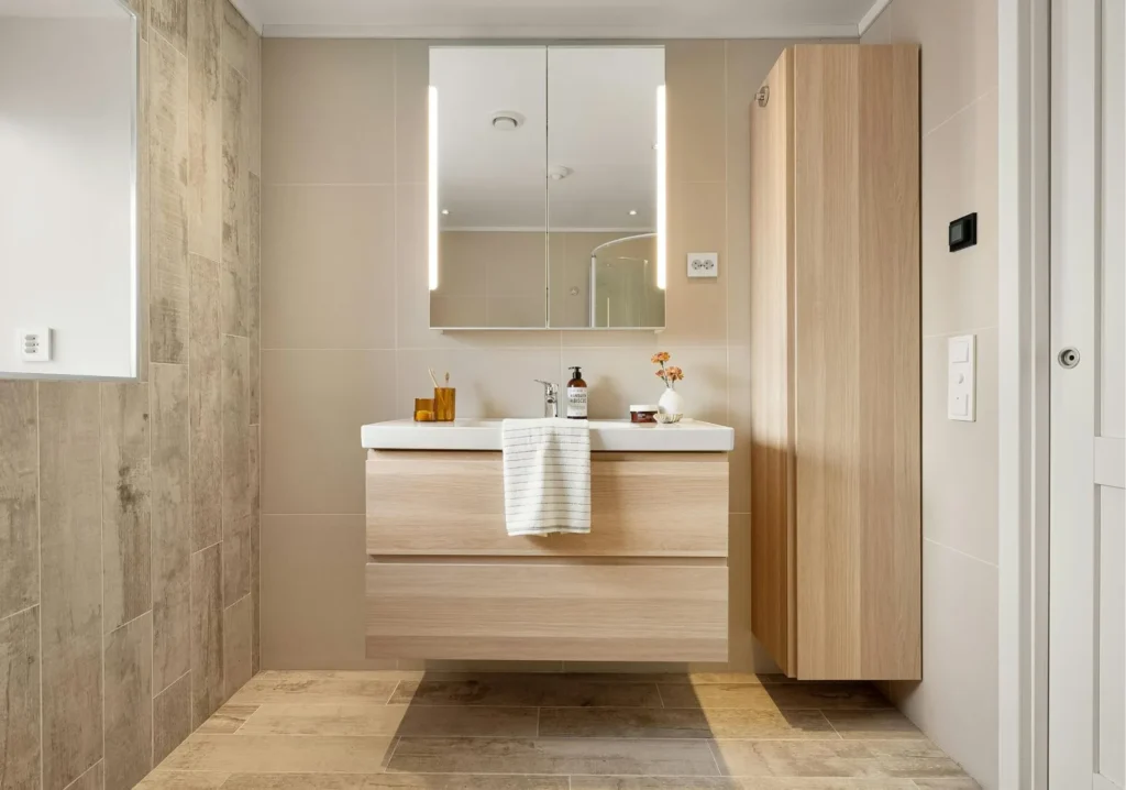 Warm light wood colored floating sink vanity design in bathroom