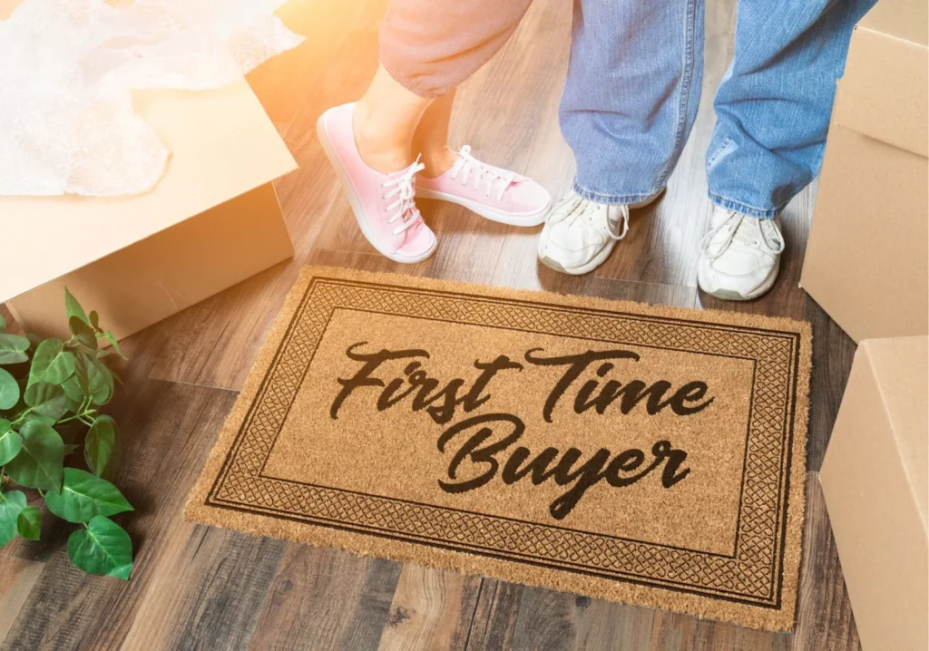 Welcome mat that says, first time buyer, with close up of man and woman feet