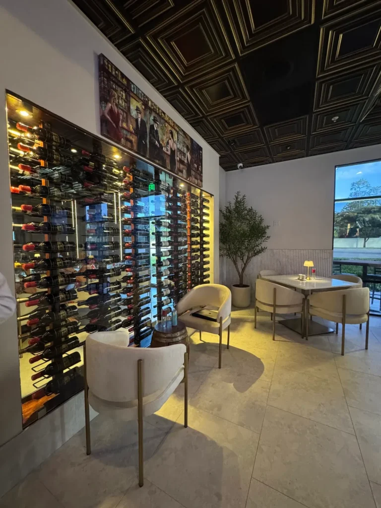 Wine wall and dining area inside Adore restaurant in Naples