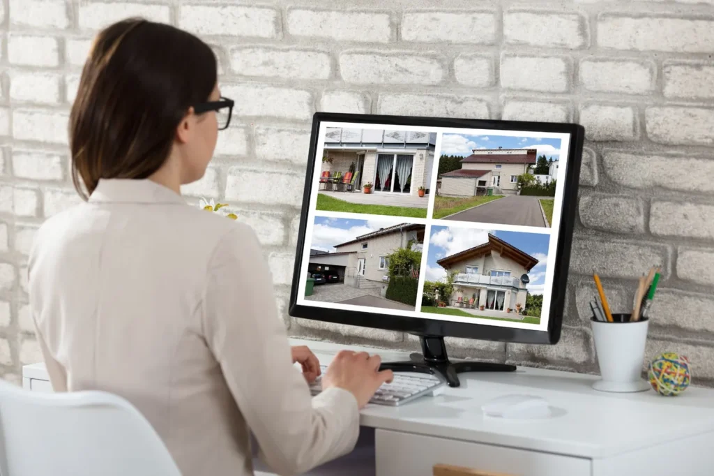 Woman browsing home listings on a computer